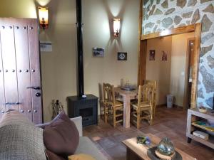 a living room with a fireplace and a table at Complejo Rural La Paloma in Arroyo de la Luz