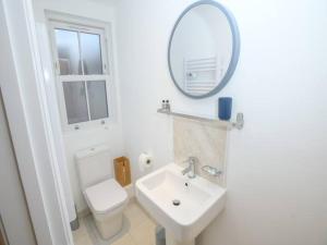 a white bathroom with a sink and a mirror at Pass the Keys Brayford room at Tavmar Apartments in Lincoln
