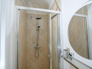 a shower in a bathroom with a round mirror at Pass the Keys Brayford room at Tavmar Apartments in Lincoln