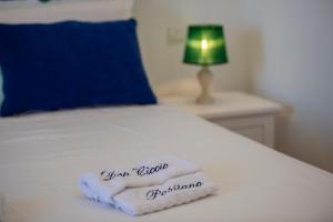 a towel on a bed with the words your good opinion at Casa Don Ciccio Positano in Positano