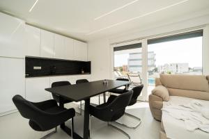 ein Wohnzimmer mit einem Tisch, Stühlen und einem Sofa in der Unterkunft Apartments Ante in Novalja