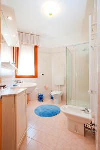 a bathroom with a sink and a toilet and a shower at Residence Roberta con piscina - Agenzia Cocal in Caorle +27 photos