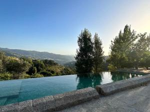 a swimming pool with a view of a mountain at Quinta de Travanca - Casa do Páteo, Baião, Douro in Baião