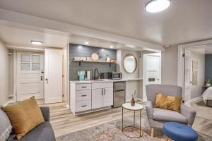a living room with a couch and a kitchen at Extended Stays & Historic DT Basement Suite in Colorado Springs