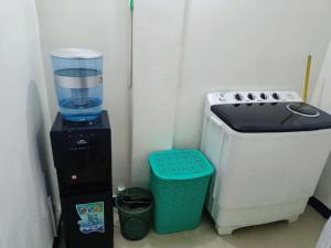 a blender and a water cooler next to a tank of water at FevKoti in Addis Ababa