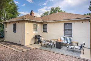 a house with a patio with a grill and chairs at Extended Stays & Historic DT Basement Suite in Colorado Springs