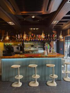 a bar with stools in front of a counter at Peace & Love Hostel in Paris