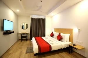 a hotel room with a bed and a television at Hotel Rudratesh in New Delhi
