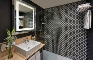 a bathroom with a sink and a mirror at NH Campo Cartagena in Cartagena