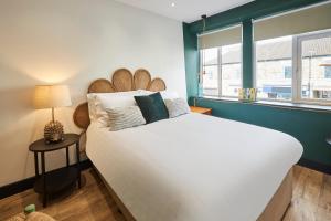 a bedroom with a large white bed and a window at The Believe Boutique (Believe Bar & Bedrooms) in Redcar +57 photos