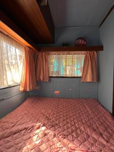 a bed in a room with two windows at Blue Oasis Lozenets in Kiten