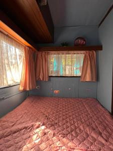 a bed in a room with two windows at Oasis Blue Lozenets in Lozenets