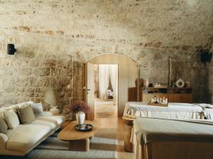 a bedroom with a bed and a couch and a table at Mamula Island in Herceg-Novi
