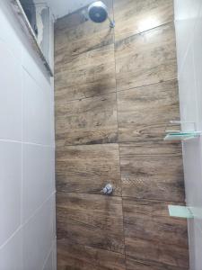 a bathroom with a shower with a wooden floor at Casa Parque de Olivenca in Pontal