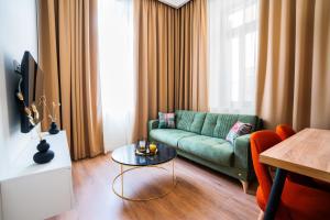 a living room with a green couch and a table at Oikia Classic House in Kavala