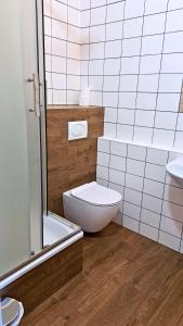 a bathroom with a white toilet and a sink at Hotel Europejski in Przemyśl
