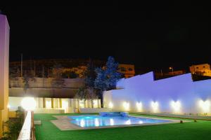 a building with a swimming pool at night at Petra Castle Hotel in Wadi Musa
