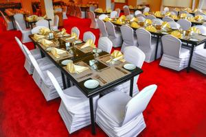 a banquet hall with tables and white chairs at Petra Castle Hotel in Wadi Musa