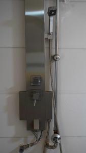 a public shower stall in a bathroom with aphone at Embu Pazuri Homes in Embu