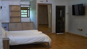 a bedroom with a bed with towels on it at Embu Pazuri Homes in Embu