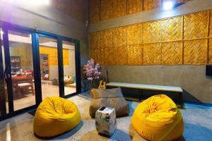 a living room with two yellow bean bag chairs at Shalmari's Hut in South Tambo