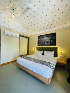 a bedroom with a large bed in a room at Nightingales Resort in Nāthdwāra