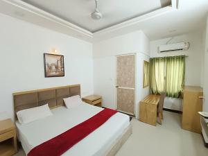 a bedroom with a large bed and a bathroom at Usha Residency in Bhuj