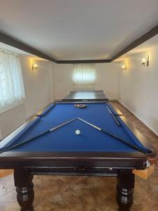 a large blue pool table in a room with at Pensiunea Mary in Moieciu de Jos