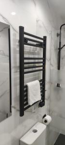 a white bathroom with a sink and a mirror at Apartamento Centro B in San Sebastián de los Reyes