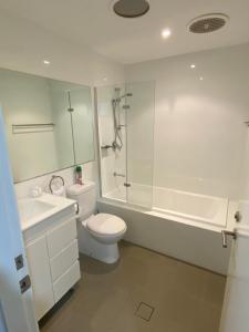 a bathroom with a toilet and a sink and a shower at Molly's on Mount View - Walk to 3 Cellar Doors in Cessnock +7 photos