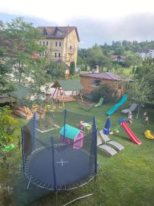 a playground with a trampoline in a yard at Pensiunea Mary in Moieciu de Jos