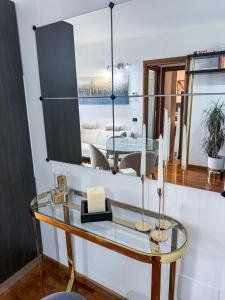 a room with a glass table and a mirror at Luxury White Apartment BGY - Orio al Serio Airport in Zanica