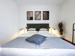 a bedroom with a large bed with two pillows at Luxury White Apartment BGY - Orio al Serio Airport in Zanica