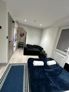 a living room with two beds and a couch at Serviced Ensuite Double Room - Near Greenwich Park - The O2 Arena - Nearby Transport Links to Central London - New Cross Station - Lewisham SE14 in London