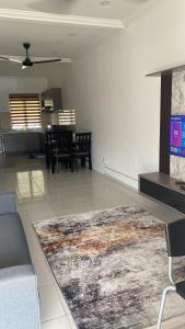 a living room with a couch and a rug at Homestay18@KLIA in Sepang