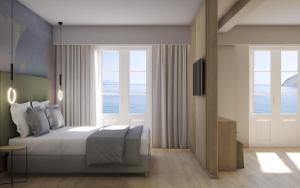 a bedroom with a bed with a view of the ocean at Nireus Hotel in Symi