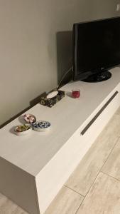 a table with two bowls and a television on it at Locazione Turistica da Cinzia 