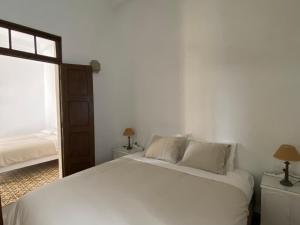 um quarto com uma cama branca e uma janela em Casa Álvaro em Fasnia