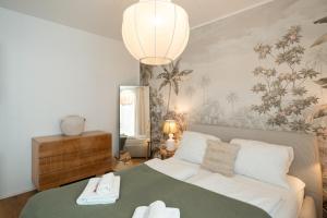 a bedroom with a bed with a green blanket at Vienna Heights Premium Apartments in Vienna