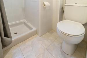 a white bathroom with a toilet and a bath tub at Les Tonyines 67 - Apartamento con vistas y terraza in Llança +17 photos