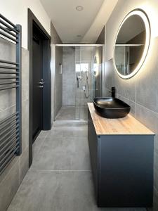 a bathroom with a sink and a mirror and a shower at Si-View Doppelzimmer Siegen Zimmer 15 in Siegen
