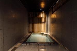 a swimming pool in a dark room with a light at Hinatamikan in Nakanojo