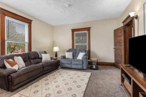 a living room with a couch and a television at Charming 4BR Westside Home in Beer City USA in Grand Rapids