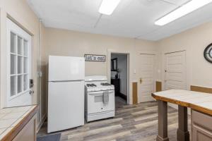 a kitchen with a white refrigerator and a stove at Charming 4BR Westside Home in Beer City USA in Grand Rapids