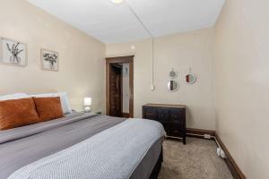 a bedroom with a large bed in a room at Charming 4BR Westside Home in Beer City USA in Grand Rapids