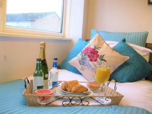 a tray of food and drinks on a bed at Honest Airport University House 1 with FREE PARKING and FAST WIFI in Southampton