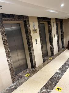 a row of elevator doors in a building at Arfalon Hotel and Tourism in Makkah