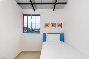 a white room with a bed and a window at Full Apartamento Privado 202 Guatapé in Guatapé