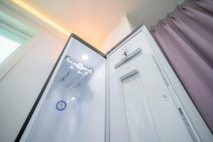 a bathroom with a white door and a curtain at Number 25 Gyeongju City Hall in Gyeongju