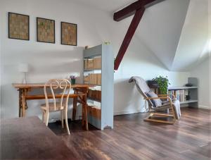 a dining room with a table and two chairs at Mansarda in Cluj-Napoca
